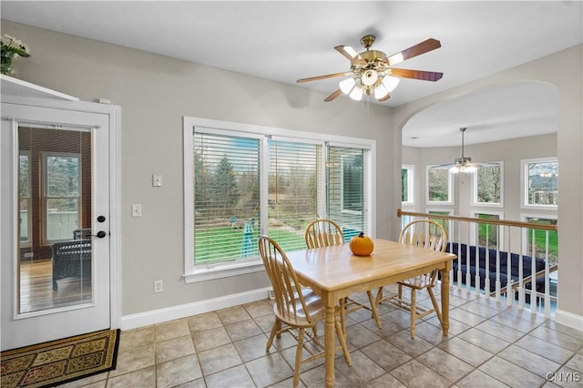 8312 Partridgeberry Dr, Lysander, NY 13027 - dining space featuring a ceiling fan, arched walkways, and healthy amount of natural light