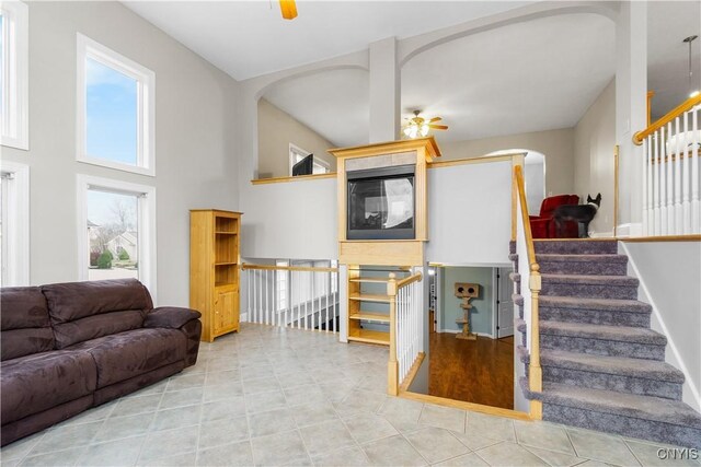 8312 Partridgeberry Dr, Lysander, NY 13027 - living area featuring a ceiling fan, arched walkways, and stairway