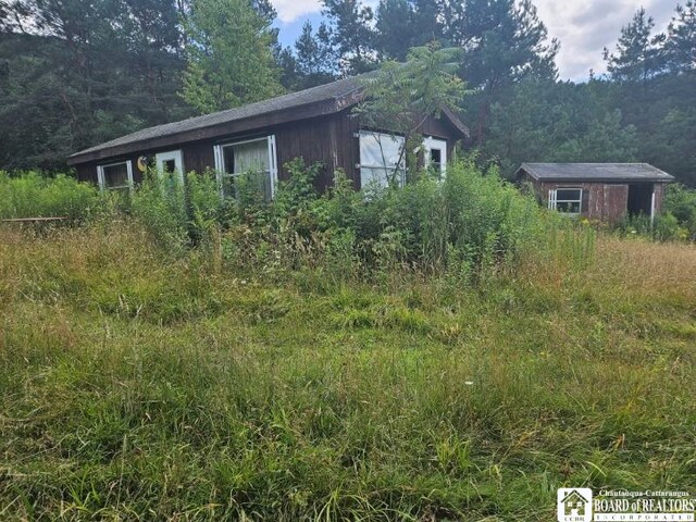 5162 Whig St, Little Valley, NY 14779 - view of side of home featuring a wooded view