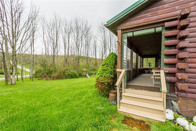 view of green lawn with a porch