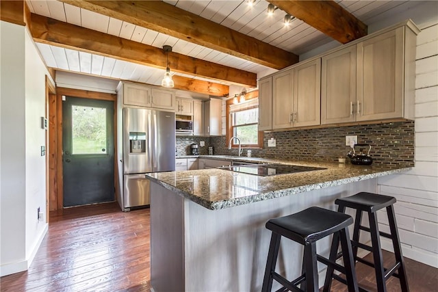 kitchen featuring appliances with stainless steel finishes, dark wood-style flooring, a peninsula, baseboards, and wooden ceiling
