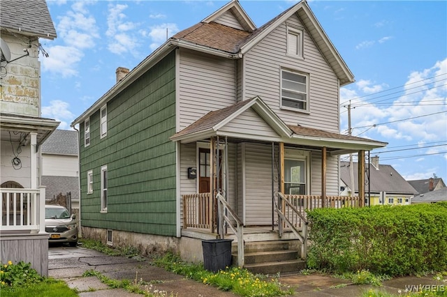 1001 15th St, Niagara Falls, NY 14301 - view of front of home with a porch, a shingled roof, and a chimney