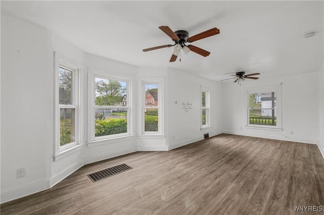 1001 15th St, Niagara Falls, NY 14301 - unfurnished living room with plenty of natural light, wood finished floors, and baseboards