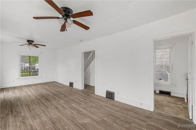 1001 15th St, Niagara Falls, NY 14301 - unfurnished living room featuring ceiling fan, wood finished floors, and baseboards