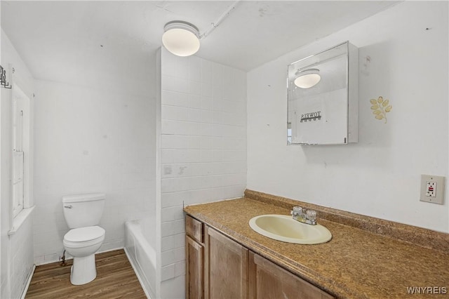 1001 15th St, Niagara Falls, NY 14301 - full bathroom with toilet, wood finished floors, vanity, and a bath