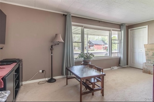 office area featuring light carpet, ornamental molding, and baseboards