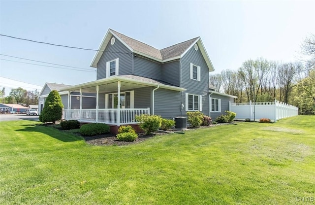 view of side of home with central AC and covered porch