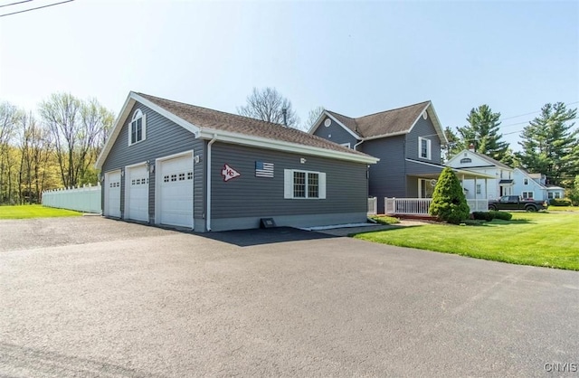 view of front of home featuring a garage and a front lawn