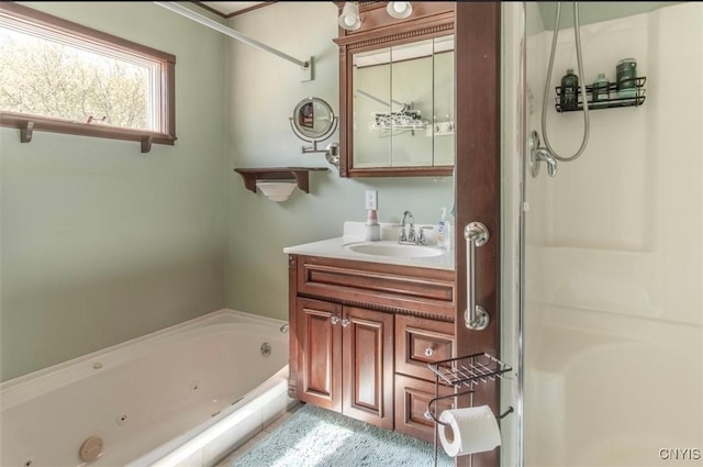 bathroom featuring a tub with jets, vanity, and a shower