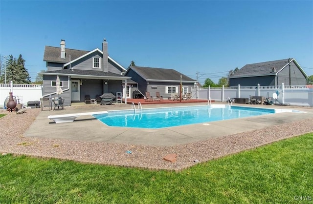 view of pool with a patio, a diving board, and a fenced backyard