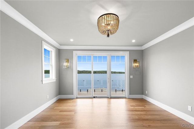 unfurnished room featuring crown molding, a chandelier, baseboards, wood finished floors, and recessed lighting