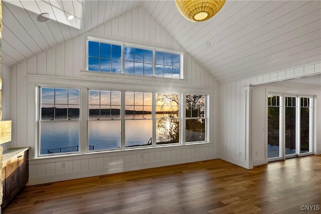 unfurnished sunroom with lofted ceiling, healthy amount of natural light, and a water view