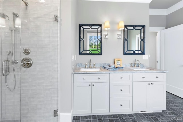 bathroom with a shower stall, double vanity, and tile patterned flooring