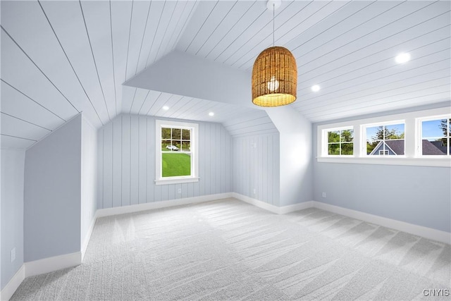 additional living space with vaulted ceiling, healthy amount of natural light, carpet flooring, baseboards, and recessed lighting