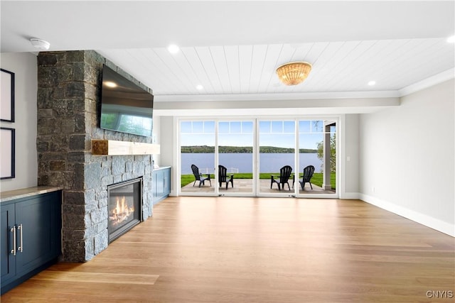 unfurnished living room with light wood-type flooring, a fireplace, baseboards, recessed lighting, and wooden ceiling