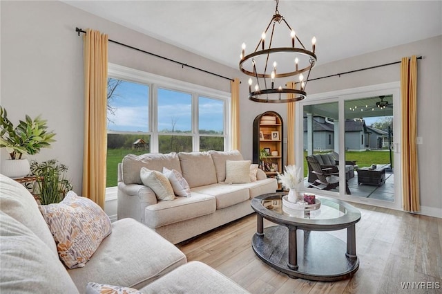 living room with a chandelier and wood finished floors