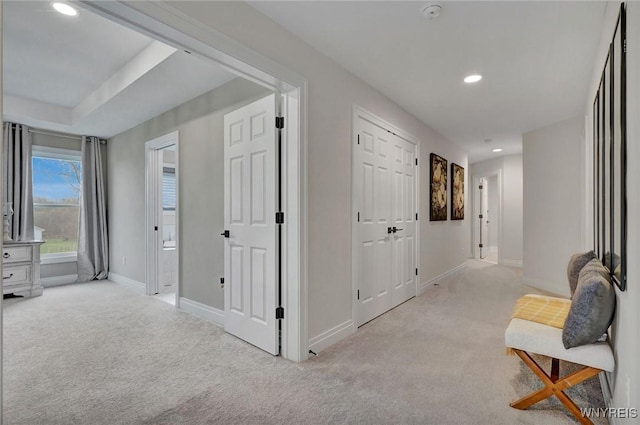 hallway with carpet flooring, baseboards, and recessed lighting