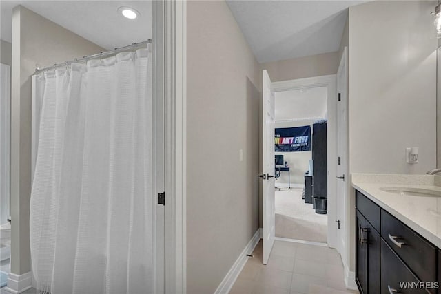 bathroom featuring vanity, baseboards, and a shower with shower curtain