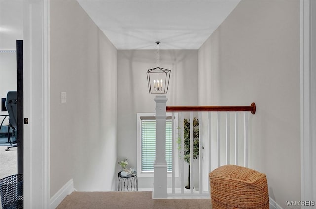foyer featuring a chandelier and baseboards