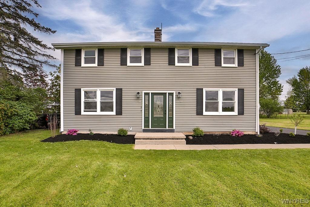 6648 Errick Rd, Wheatfield, NY 14120 - view of front of home featuring a front lawn and a chimney