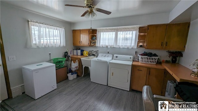 3738 E Lake Rd, Dunkirk-Town, NY 14048 - laundry room featuring separate washer and dryer, cabinet space, ceiling fan, and light wood-type flooring