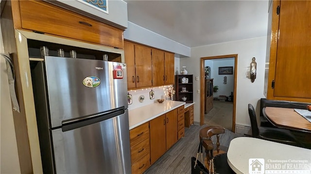 3738 E Lake Rd, Dunkirk-Town, NY 14048 - kitchen with freestanding refrigerator, brown cabinets, light countertops, dark wood-type flooring, and a baseboard heating unit
