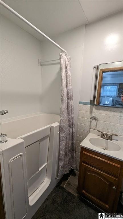 3738 E Lake Rd, Dunkirk-Town, NY 14048 - full bathroom featuring tile walls, vanity, and a shower with curtain