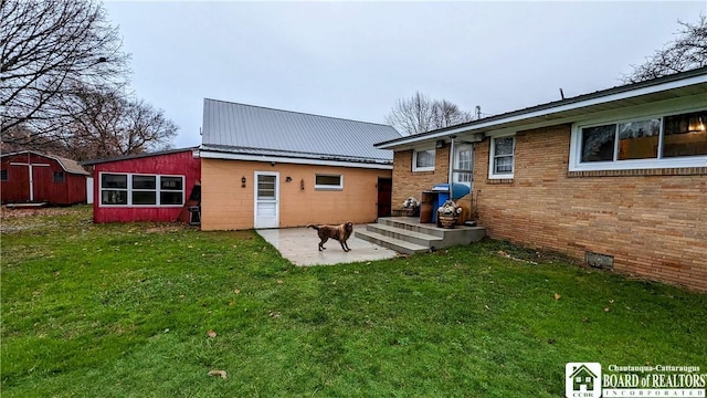 3738 E Lake Rd, Dunkirk-Town, NY 14048 - back of house with a yard, a patio, metal roof, and an outdoor structure