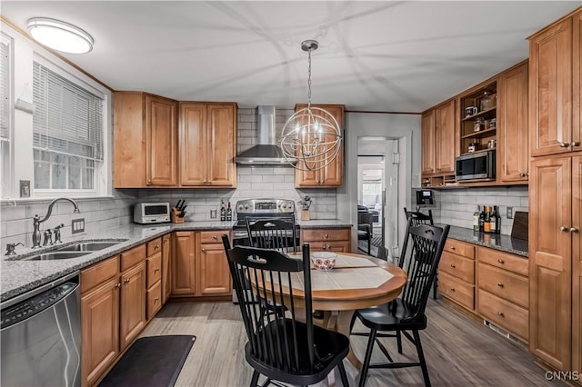 2810 Genesee St, Utica, NY 13502 - kitchen with wall chimney range hood, stainless steel appliances, a sink, backsplash, and light wood-style flooring