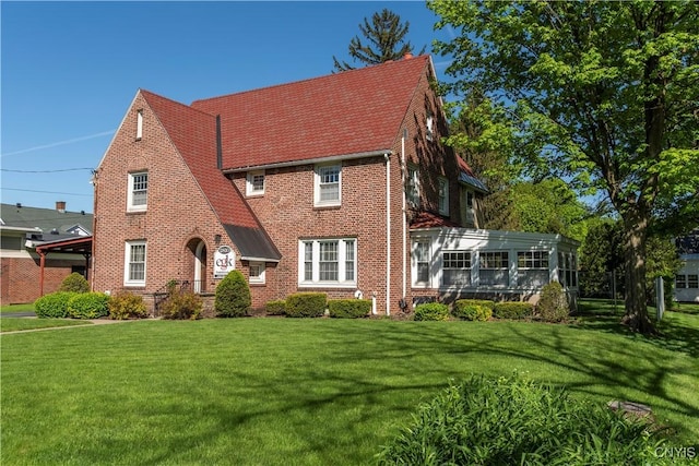 2810 Genesee St, Utica, NY 13502 - english style home featuring a front lawn and brick siding