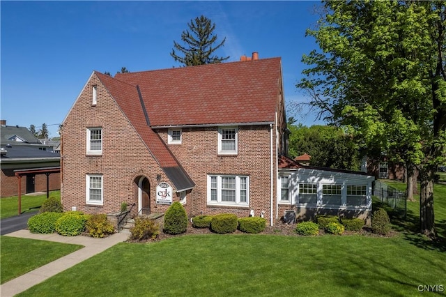 2810 Genesee St, Utica, NY 13502 - tudor home with brick siding and a front lawn