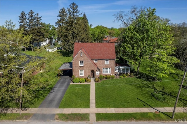 2810 Genesee St, Utica, NY 13502 - view of front facade featuring a front yard, a carport, driveway, and a chimney