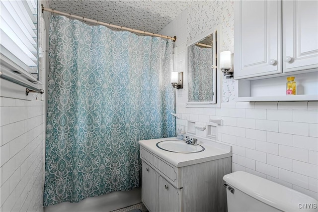 2810 Genesee St, Utica, NY 13502 - full bath featuring tile walls, toilet, vanity, and tasteful backsplash