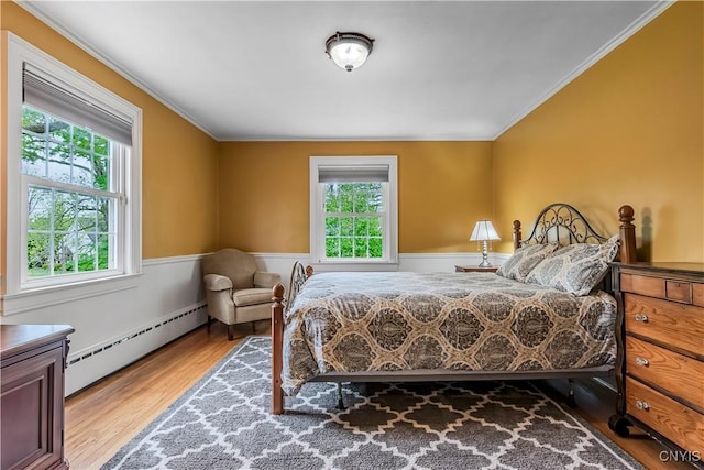 2810 Genesee St, Utica, NY 13502 - bedroom featuring a baseboard radiator, multiple windows, wood finished floors, ornamental molding, and a wainscoted wall
