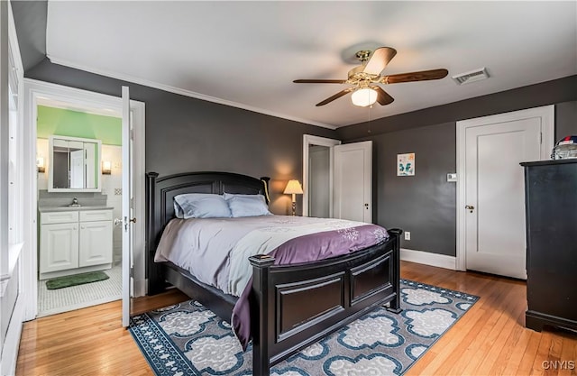 2810 Genesee St, Utica, NY 13502 - bedroom featuring wood finished floors, ensuite bathroom, baseboards, ceiling fan, and crown molding