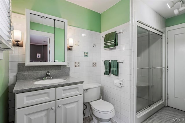 2810 Genesee St, Utica, NY 13502 - full bathroom with tile walls, a stall shower, vanity, toilet, and tile patterned floors