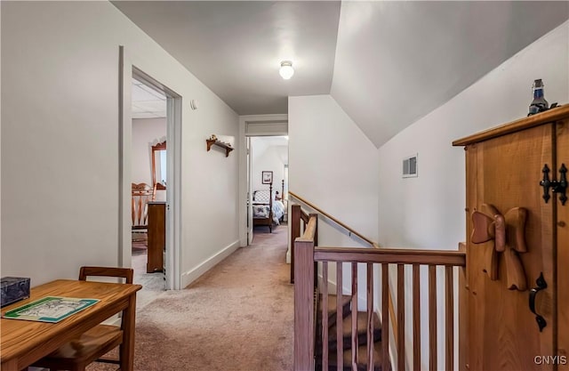 2810 Genesee St, Utica, NY 13502 - corridor with light colored carpet, lofted ceiling, an upstairs landing, and baseboards