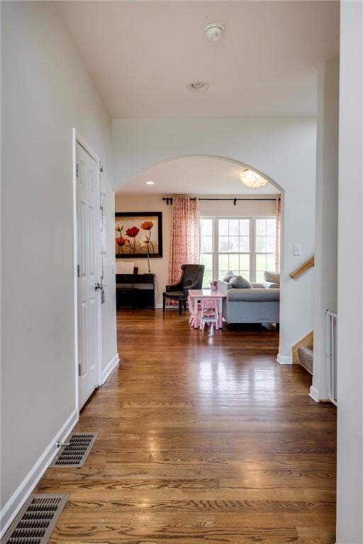 318 Wexford Ln, Horseheads, NY 14845 - hall featuring arched walkways, wood finished floors, stairs, and baseboards