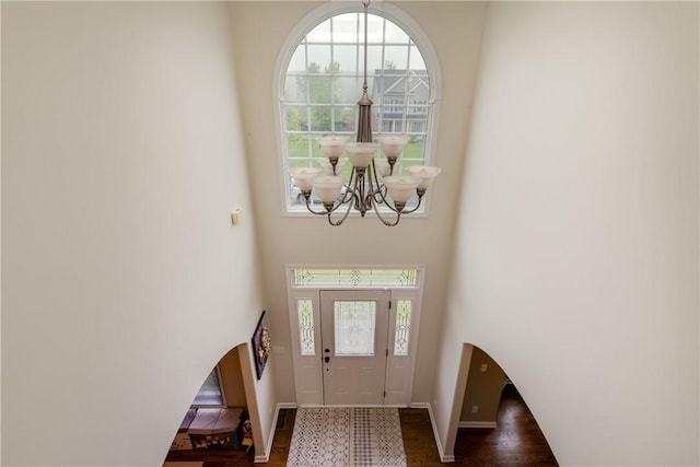 318 Wexford Ln, Horseheads, NY 14845 - foyer with a chandelier, baseboards, a high ceiling, and dark wood finished floors