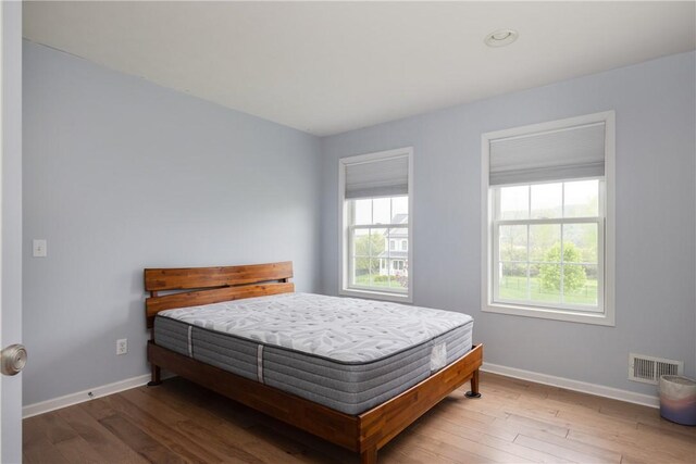 318 Wexford Ln, Horseheads, NY 14845 - bedroom featuring multiple windows, baseboards, and wood finished floors