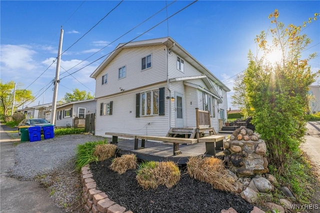 back of house with a deck