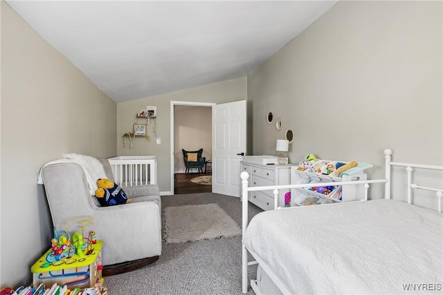 carpeted bedroom featuring lofted ceiling