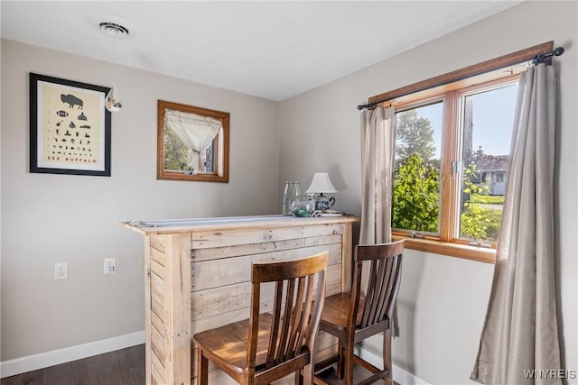 dining area with baseboards and dark wood-style floors