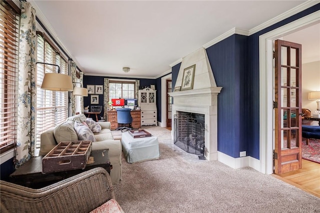 living room with an office area, crown molding, carpet, a fireplace, and baseboards