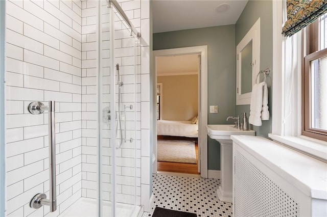 ensuite bathroom with a stall shower and baseboards