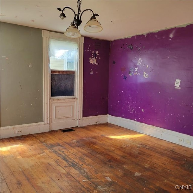 83 W Main St, Milford, NY 13807 - unfurnished dining area with wood-type flooring, a chandelier, and baseboards