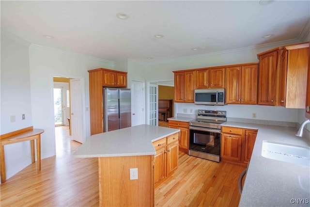 490 Hidden Falls Rd, Tully, NY 13159 - kitchen featuring stainless steel appliances, a sink, a center island, light countertops, and light wood-style floors