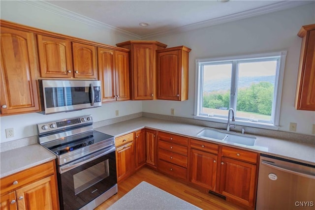 490 Hidden Falls Rd, Tully, NY 13159 - kitchen featuring stainless steel appliances, a sink, light wood finished floors, light countertops, and brown cabinets
