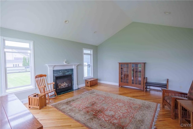 490 Hidden Falls Rd, Tully, NY 13159 - living room featuring vaulted ceiling, wood finished floors, a fireplace, and baseboards