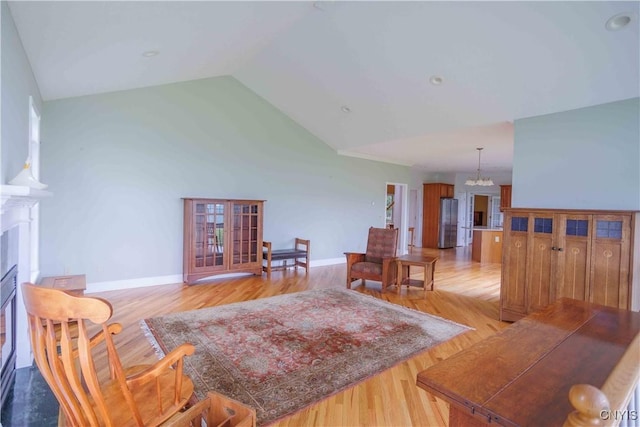 490 Hidden Falls Rd, Tully, NY 13159 - living room with lofted ceiling, a chandelier, light wood finished floors, and baseboards
